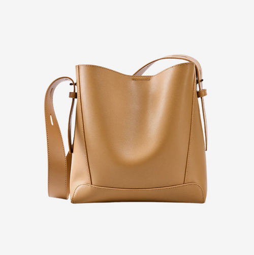 Tan leather bucket bag with adjustable shoulder strap in Sand