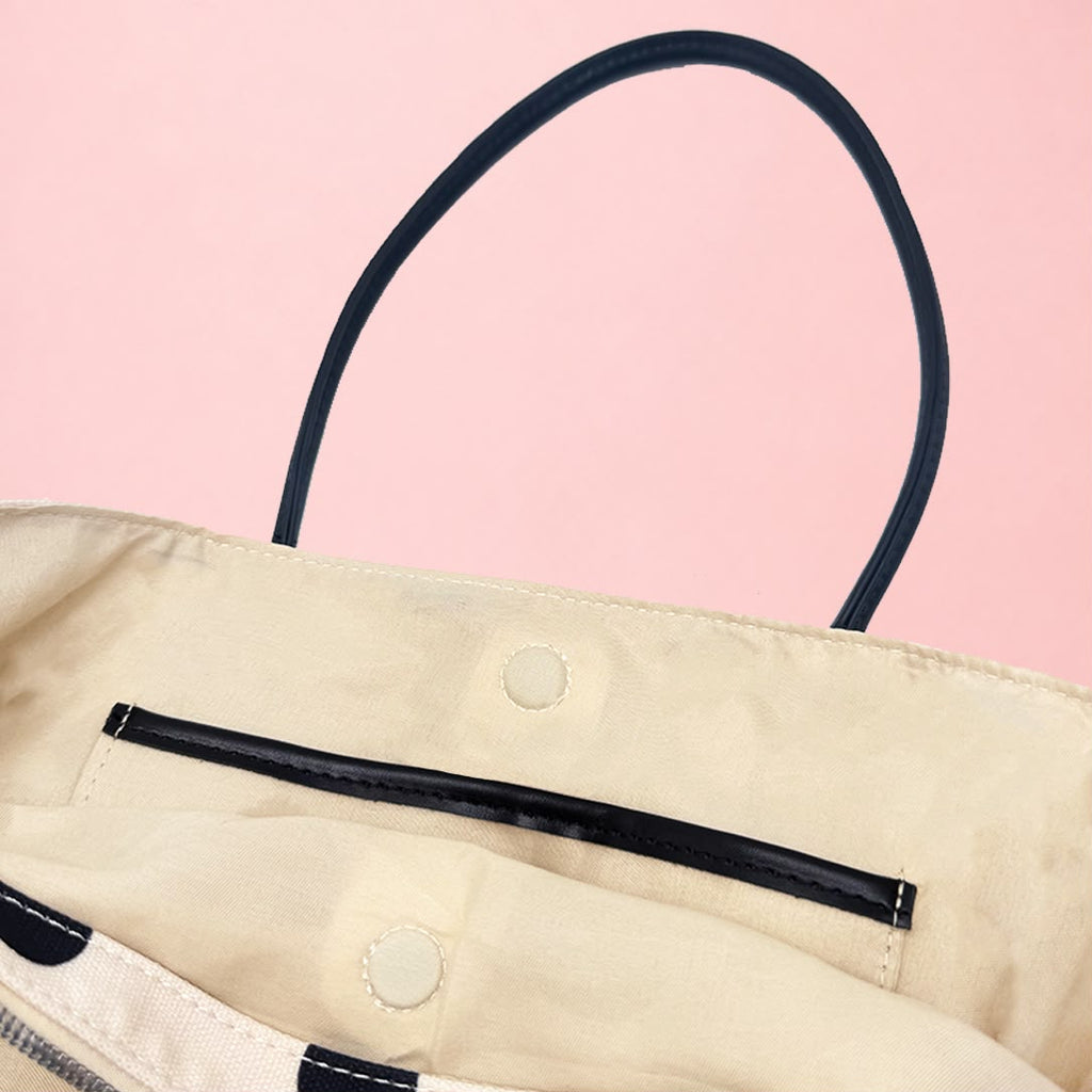 Interior snap closure and handle attachment on TOGGO Goods linen tote bag